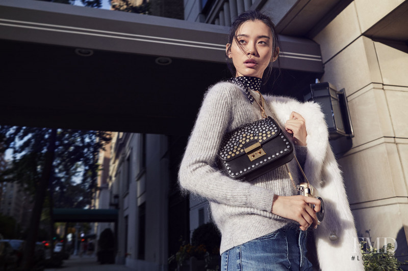 Ming Xi featured in  the Michael Kors Collection The Walk advertisement for Holiday 2016