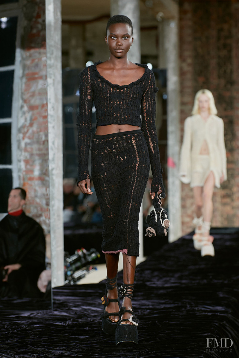 Achenrin Madit featured in  the Acne Studios fashion show for Spring/Summer 2022