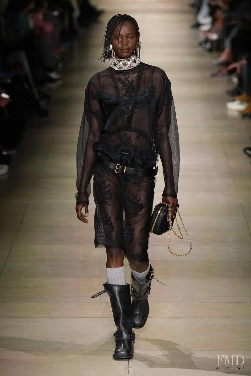 Achan Biong featured in  the Miu Miu fashion show for Autumn/Winter 2022