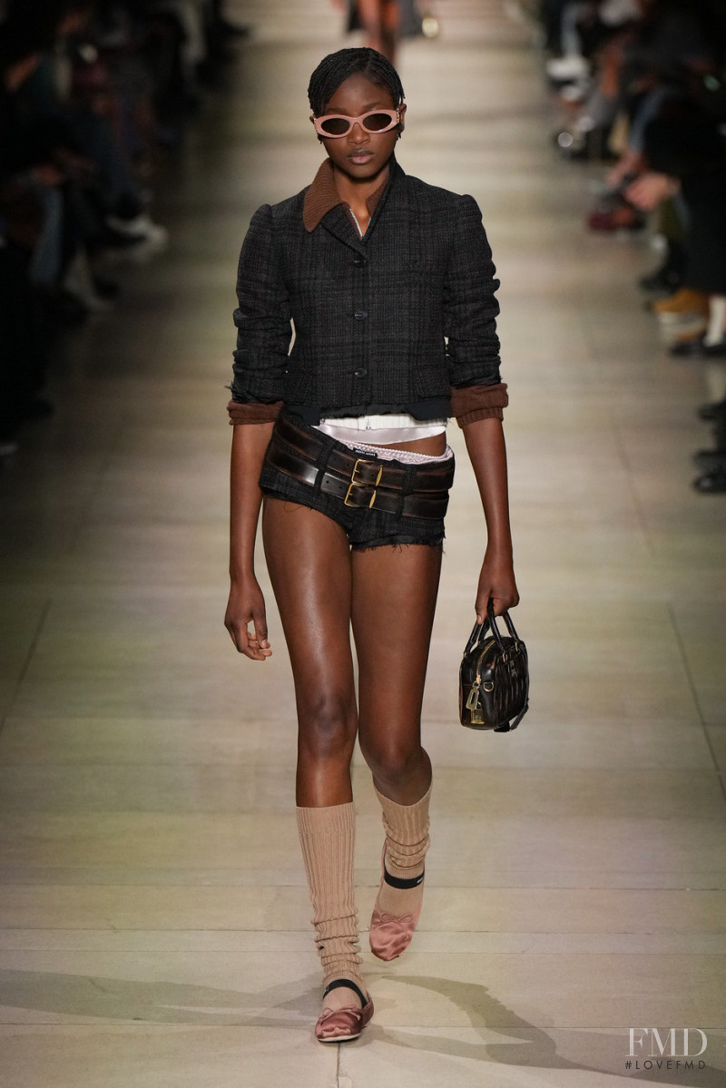 Tina Diedhiou featured in  the Miu Miu fashion show for Autumn/Winter 2022