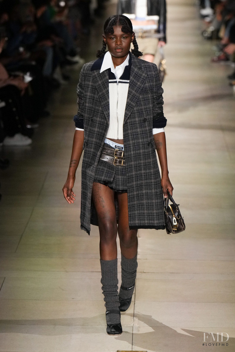 Coumba Samba featured in  the Miu Miu fashion show for Autumn/Winter 2022