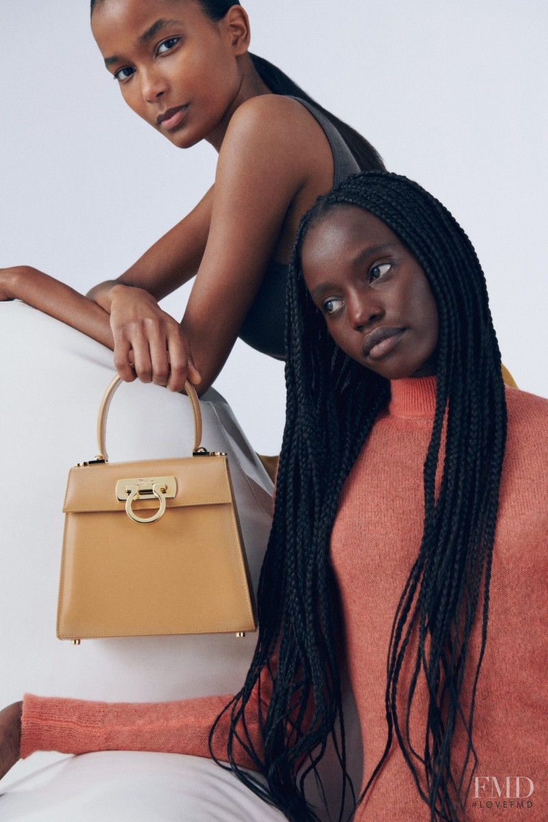 Achan Biong featured in  the Salvatore Ferragamo Top Handle Bag advertisement for Spring/Summer 2022