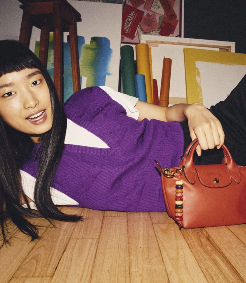 Wang Han featured in  the Longchamp A Flat-Share In Paris advertisement for Spring/Summer 2024