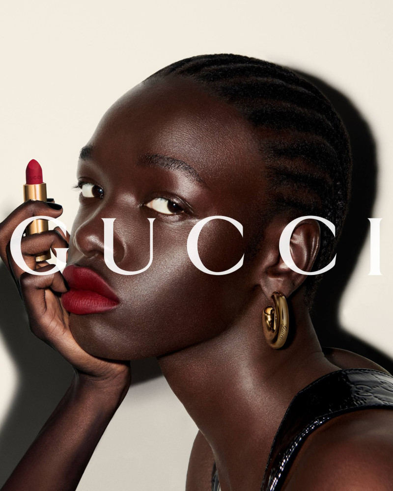 Nyajuok Gatdet featured in  the Gucci Beauty Gucci Rosso Ancora 2024 Campaign advertisement for Summer 2024